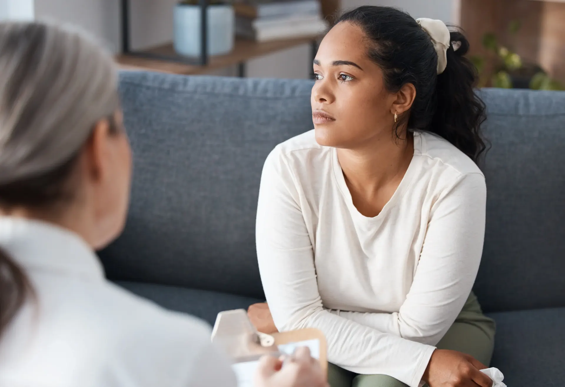 Female counselor with patient on couch.