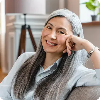 Smiling woman on couch.