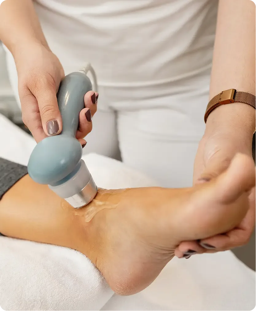 Healthcare practitioner providing shockwave therapy to patient.